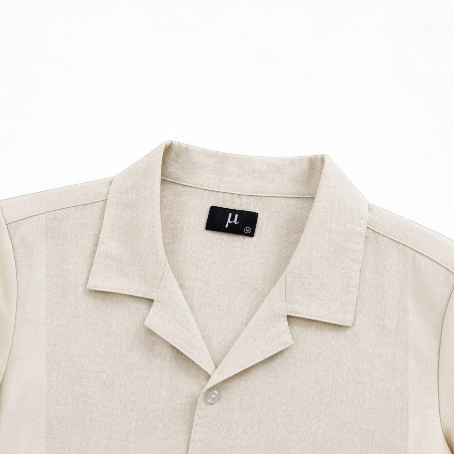 MU SHOP beige linen shirt with a soft structured collar and button closure. Relaxed fit, breathable fabric.